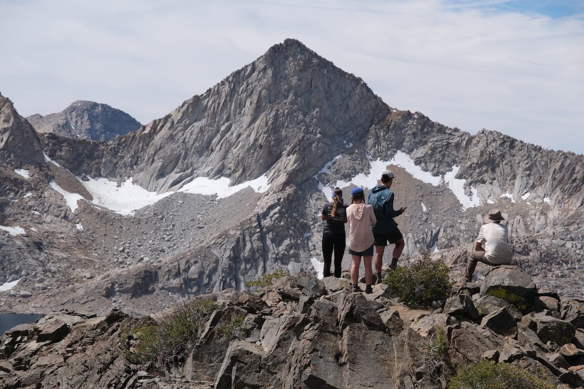 Young Americans standing together on a scenic mountain summit during an outdoor adventure